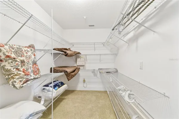 a view of staircase with railing and white walls