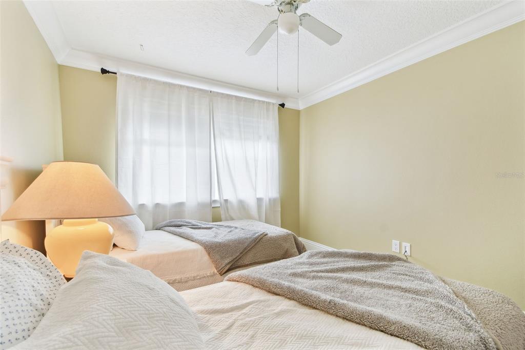 16033 Gulf Boulevard Redington Beach, FL 33708 - Photo 46 of 98 a bedroom with a bed and a lamp