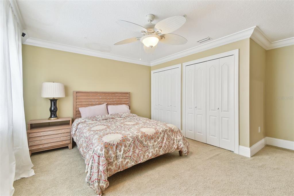 16033 Gulf Boulevard Redington Beach, FL 33708 - Photo 52 of 98 a bedroom with a bed and a chandelier