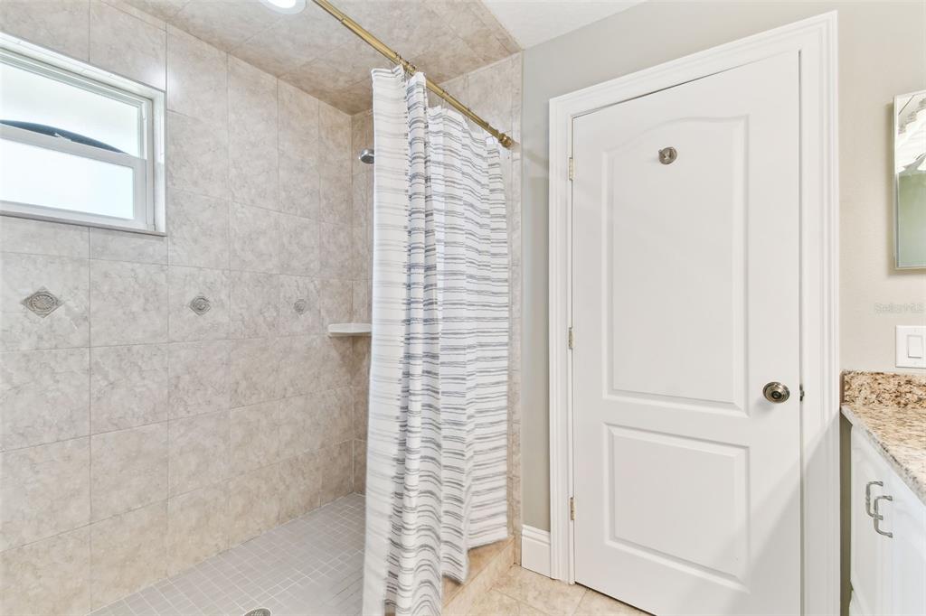 16033 Gulf Boulevard Redington Beach, FL 33708 - Photo 56 of 98 a bathroom with a shower and a door