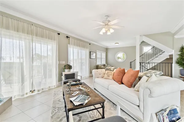 a dining room with furniture potted plants and wooden floor