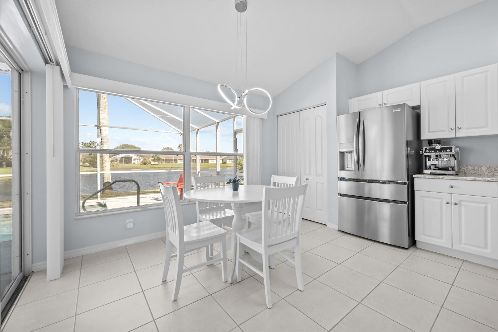 1116 Compass Row St. Augustine, FL 32080 - Photo 23 of 68 featuring a water view, vaulted ceiling, light tile patterned floors, and a chandelier