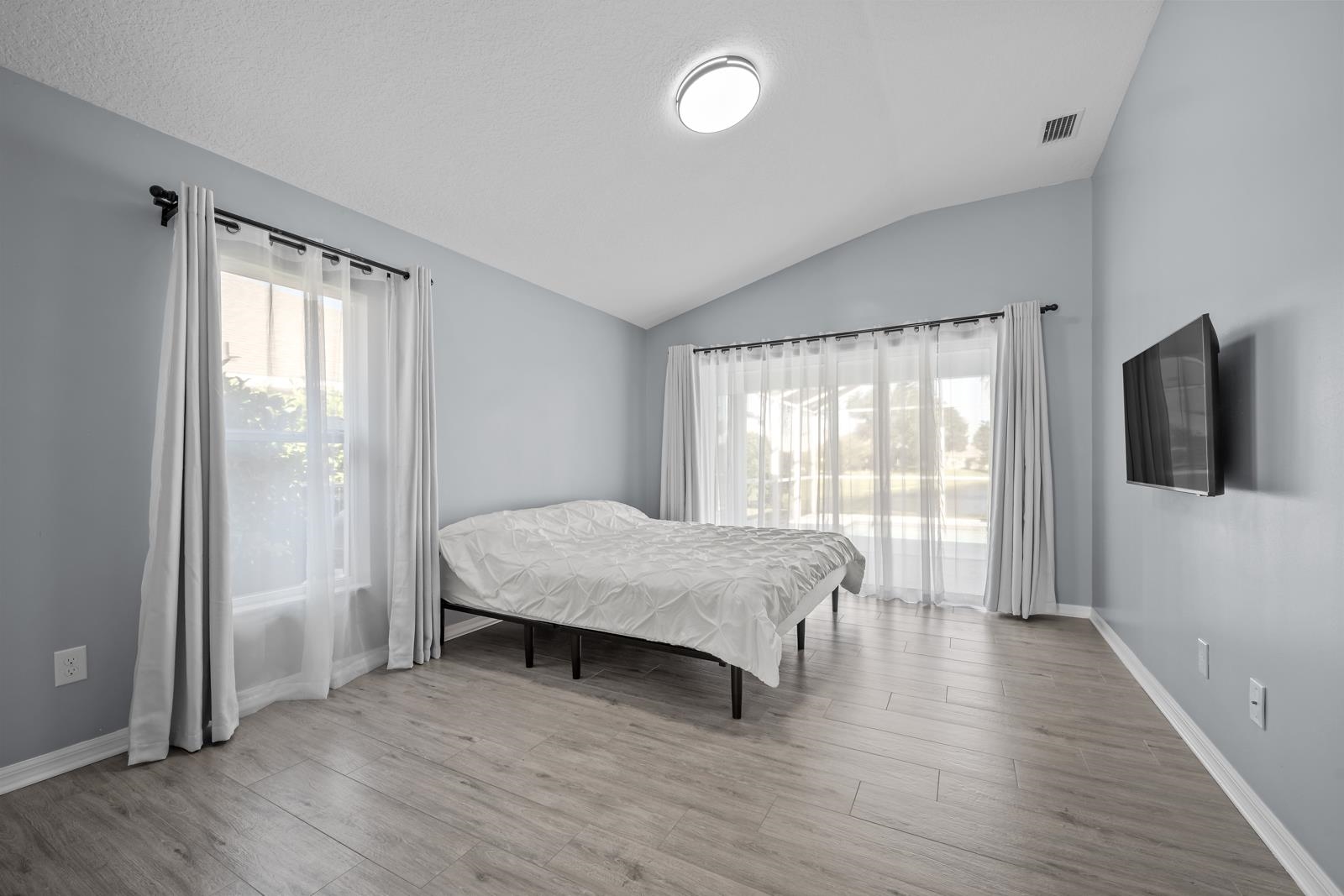 1116 Compass Row St. Augustine, FL 32080 - Photo 25 of 68 featuring access to outside and water view, multiple windows, vaulted ceiling, and light wood finished floors