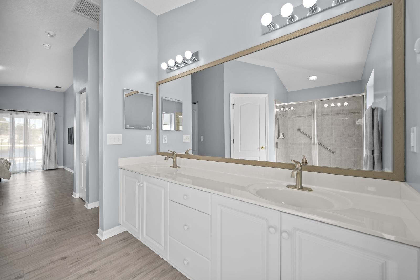 1116 Compass Row St. Augustine, FL 32080 - Photo 29 of 68 Full bath with double vanity, tiled shower, light wood-style flooring, and recessed lighting