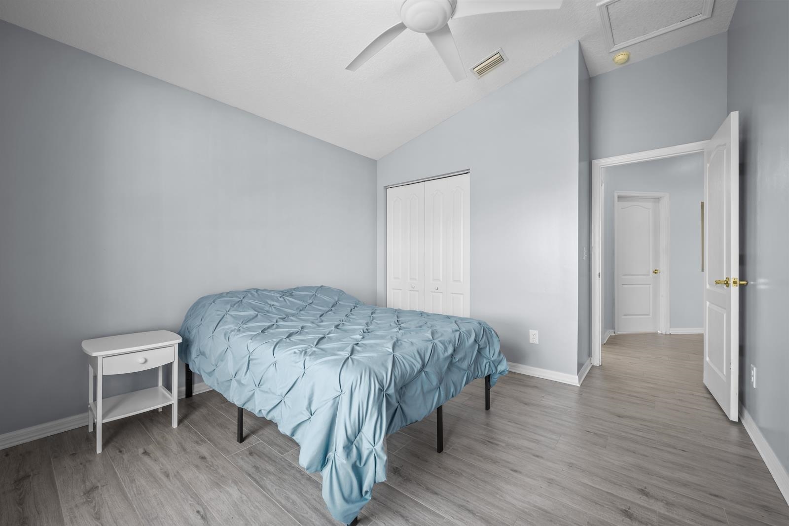 1116 Compass Row St. Augustine, FL 32080 - Photo 31 of 68 Bedroom with vaulted ceiling, wood finished floors, a closet, and ceiling fan