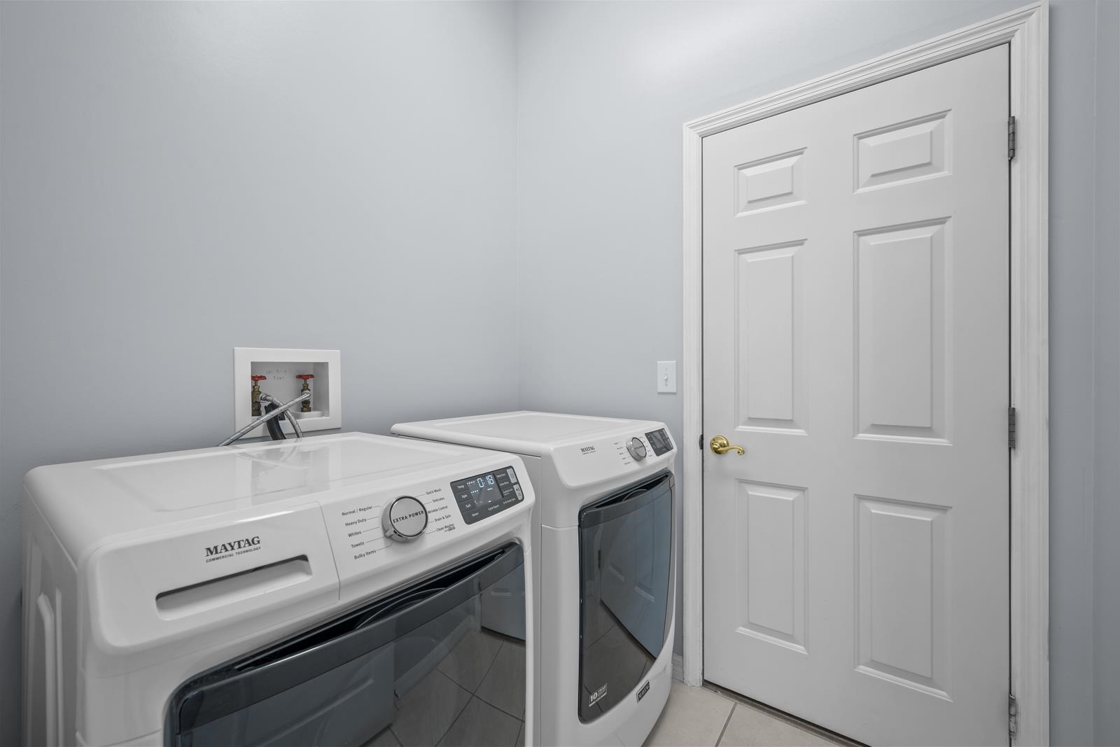 1116 Compass Row St. Augustine, FL 32080 - Photo 34 of 68 Laundry area with separate washer and dryer and light tile patterned floors