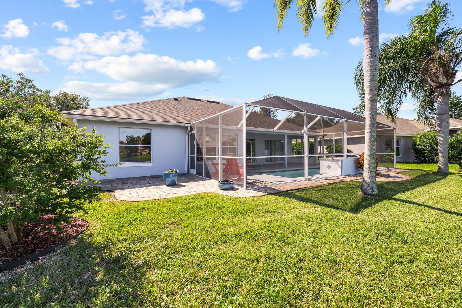 1116 Compass Row St. Augustine, FL 32080 - Photo 46 of 68 Rear view of house with a patio, glass enclosure, an outdoor pool, a sunroom, and a yard