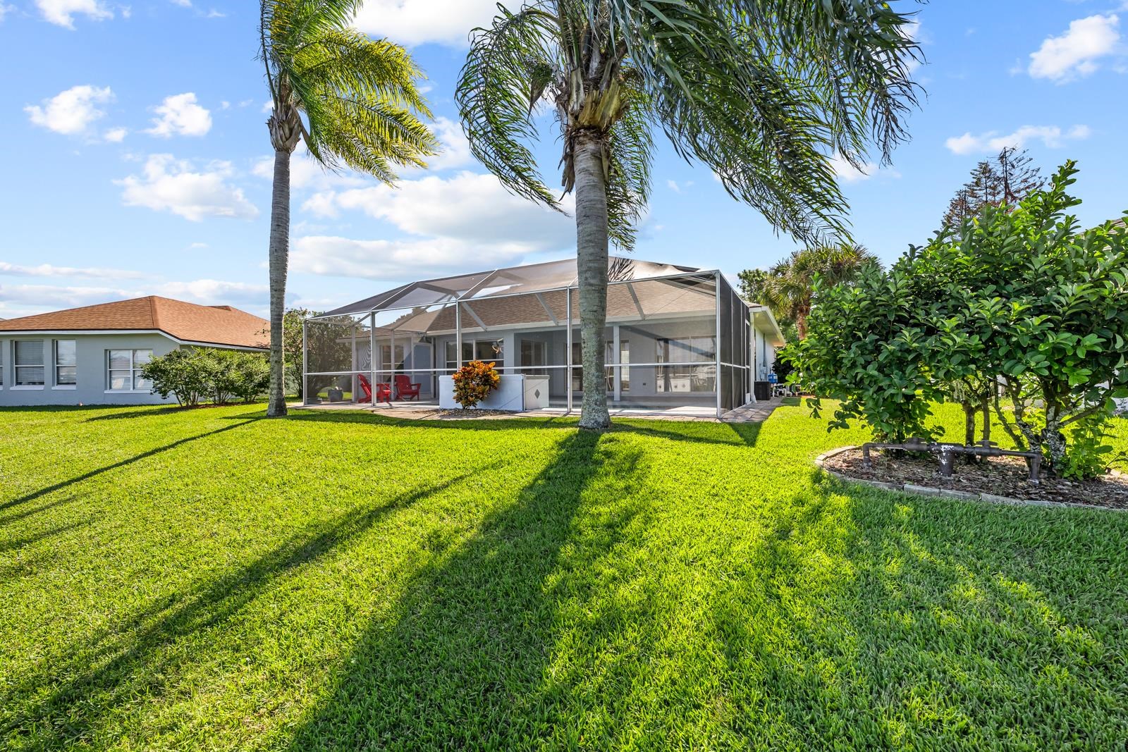 1116 Compass Row St. Augustine, FL 32080 - Photo 49 of 68 Back of property featuring glass enclosure, a sunroom, and a lawn