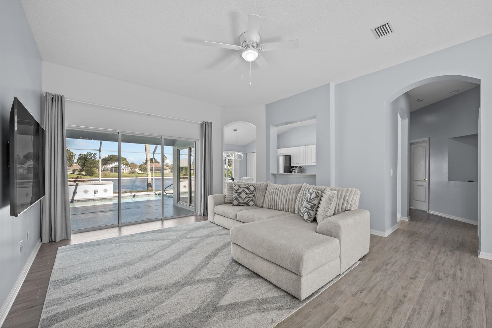 1116 Compass Row St. Augustine, FL 32080 - Photo 8 of 68 Living room with arched walkways, ceiling fan, and wood finished floors