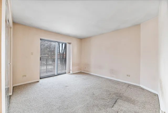 a view of an empty room with glass door
