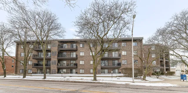 a view of roof and house with trees in the background