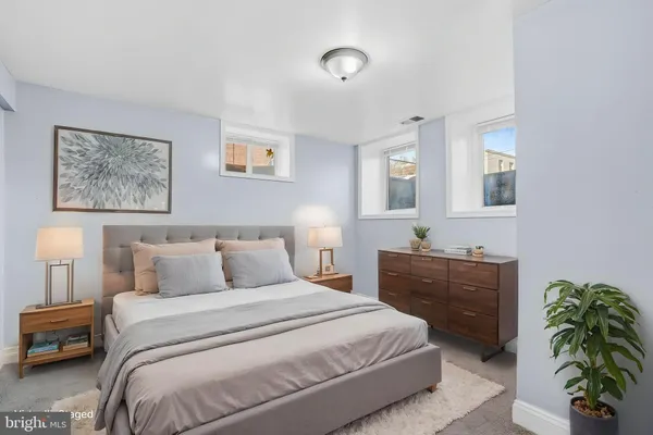 a bedroom with a bed and a dresser