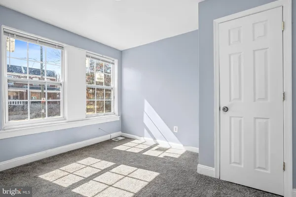 a view of a room that has a bed in it