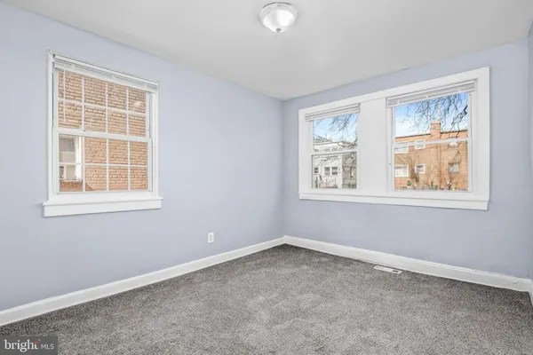 an empty room with windows and closet