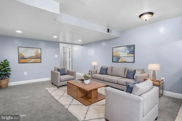 a living room with furniture and a potted plant