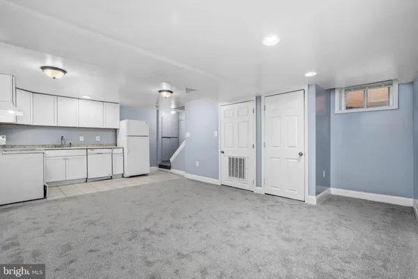 a view of a kitchen with a sink and cabinets