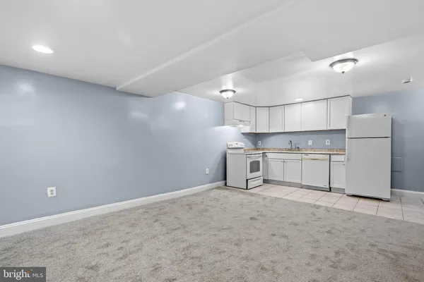 a view of a kitchen with a sink and a refrigerator