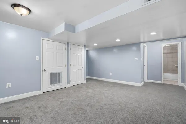 an empty room with closet area