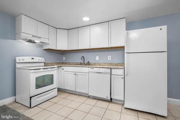 a kitchen with cabinets appliances and a sink