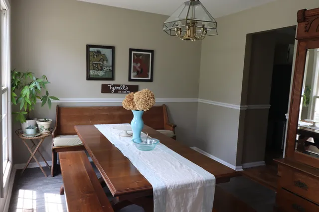 a dining room with furniture and window