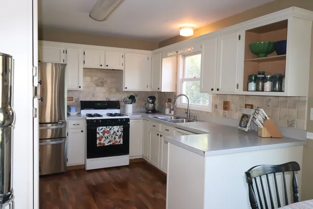 a kitchen with a refrigerator stove and sink