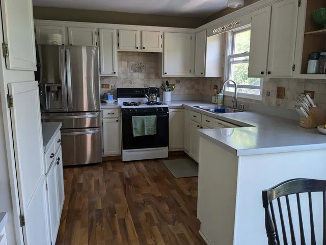 a kitchen with stainless steel appliances a refrigerator sink and stove
