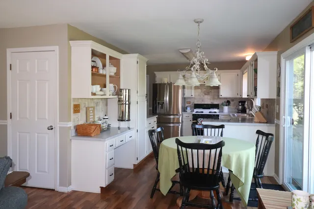 a view of a dining room with furniture large window and wooden floor
