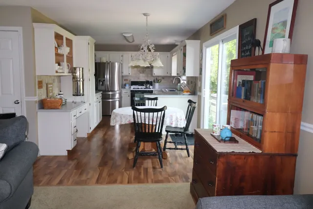 a living room with stainless steel appliances kitchen island granite countertop furniture and a kitchen view