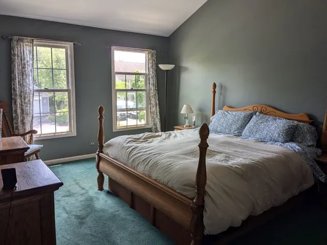 a bedroom with a bed and window