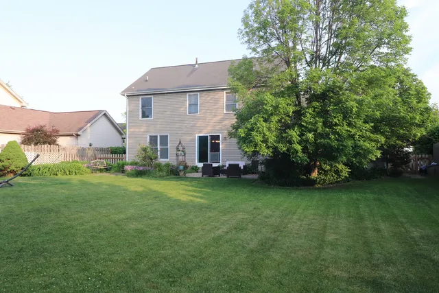 a aerial view of a house next to a big yard and large trees
