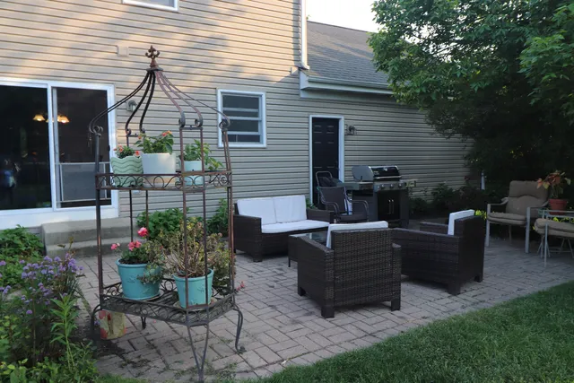 a view of backyard with outdoor seating and plants