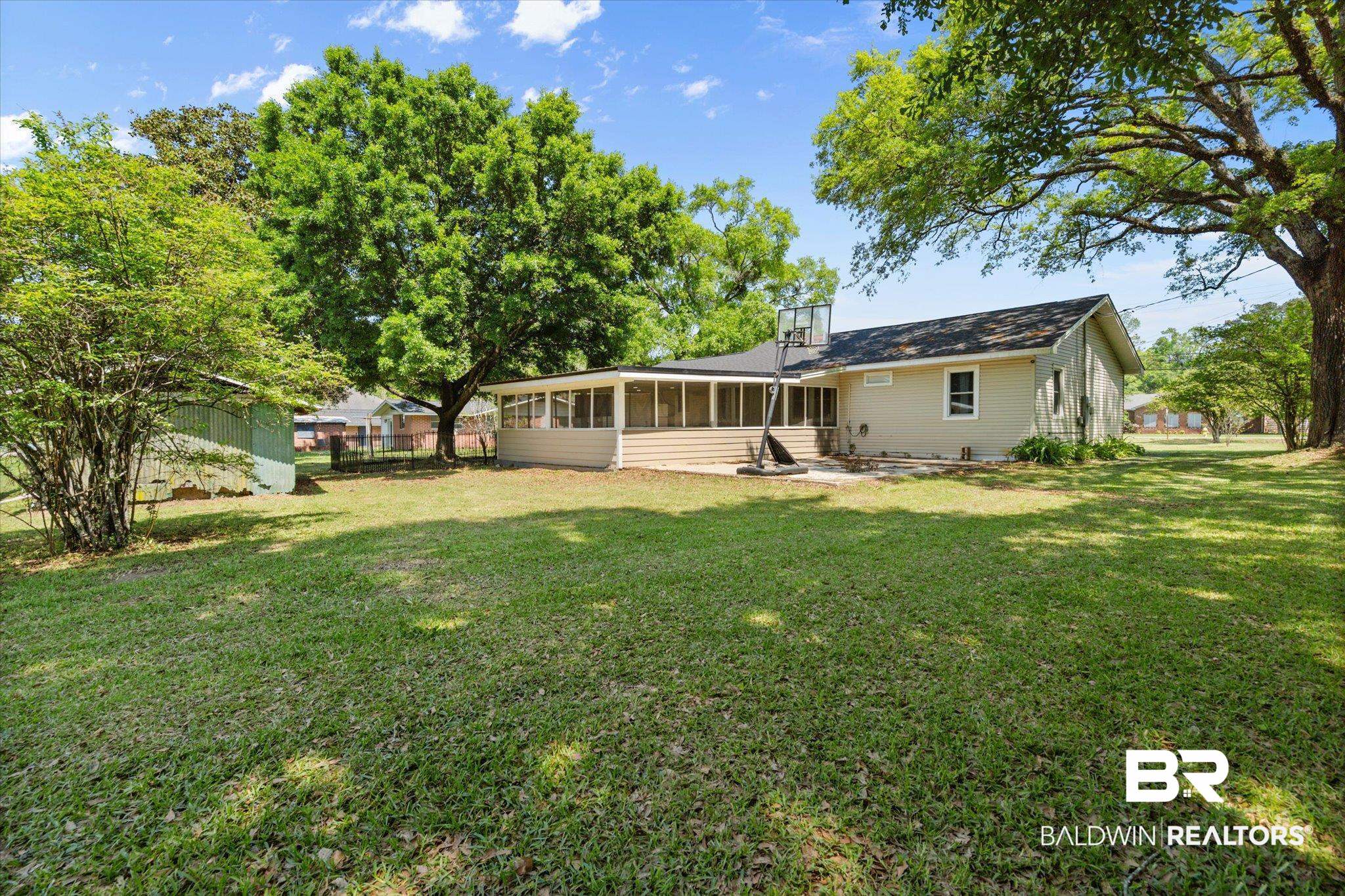 529 Cleveland Road Saraland, AL 36571 - Photo 26 of 31 Rear view of property with fence, a yard, and a sunroom