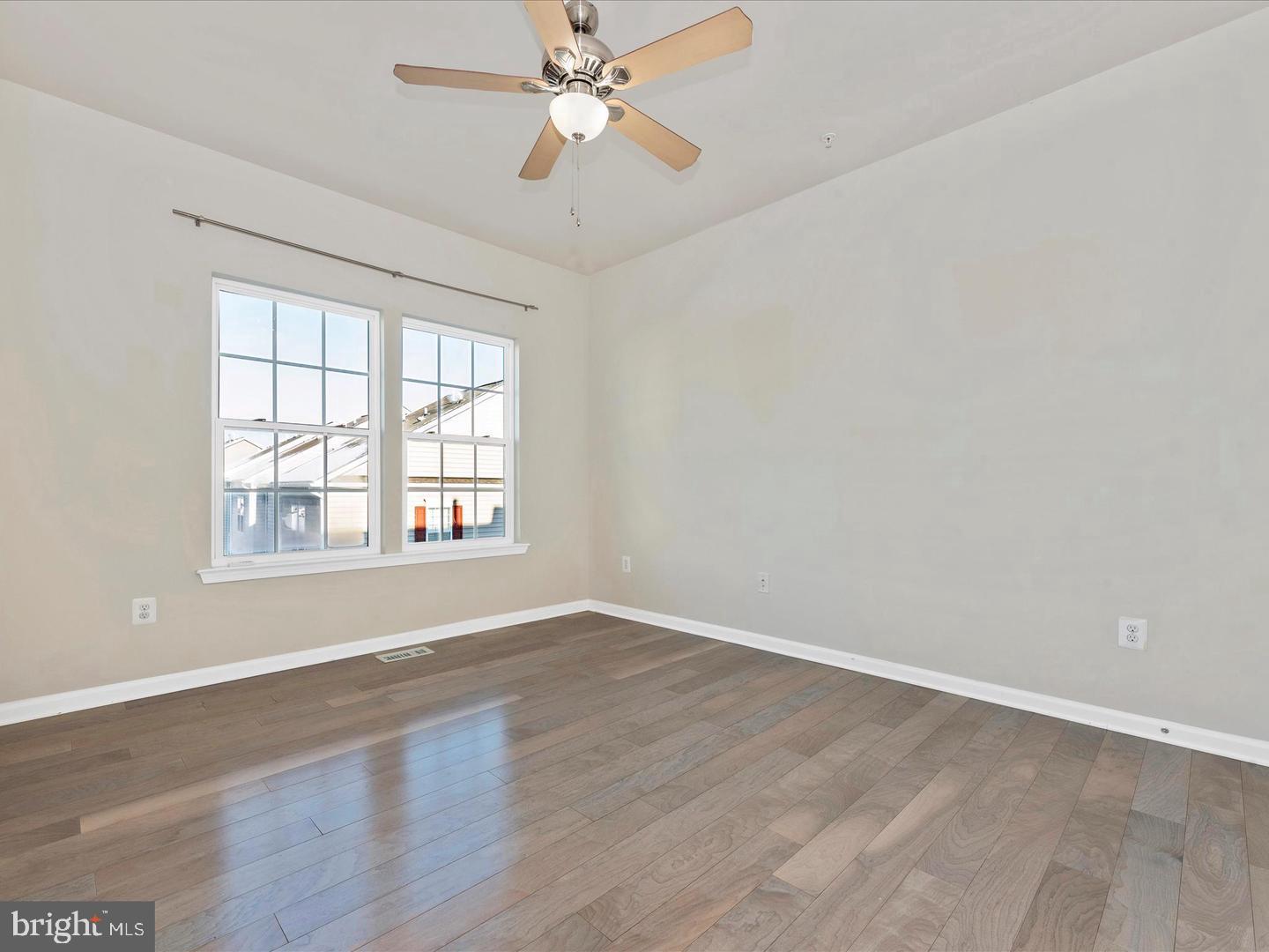 208 B Mill Pond Road Frederick, MD 21701 - Photo 30 of 45 an empty room with wooden floor fan and windows