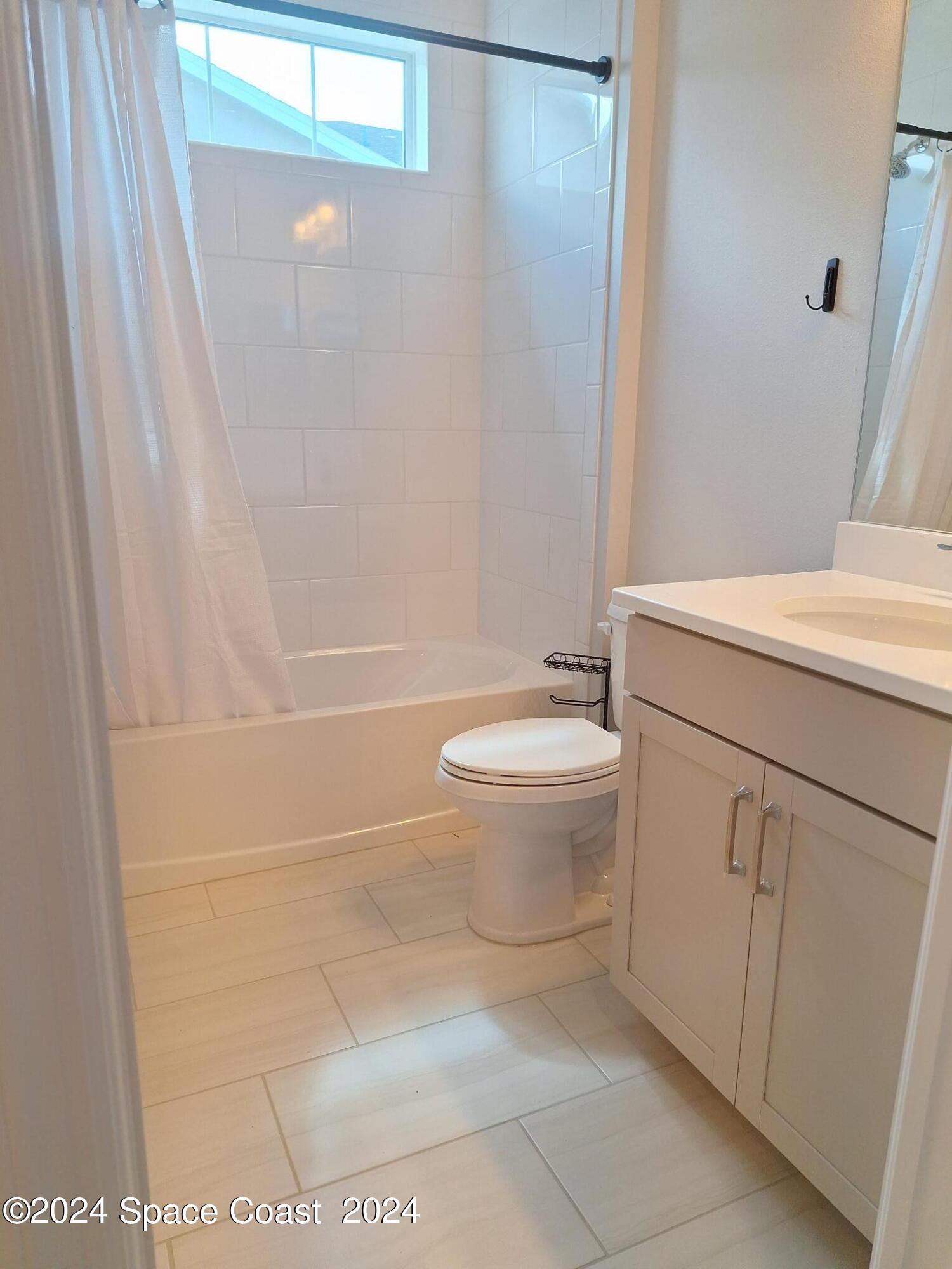 7929 Cache Crk Lane Melbourne, FL 32940 - Photo 16 of 33 a bathroom with a sink a toilet and a shower