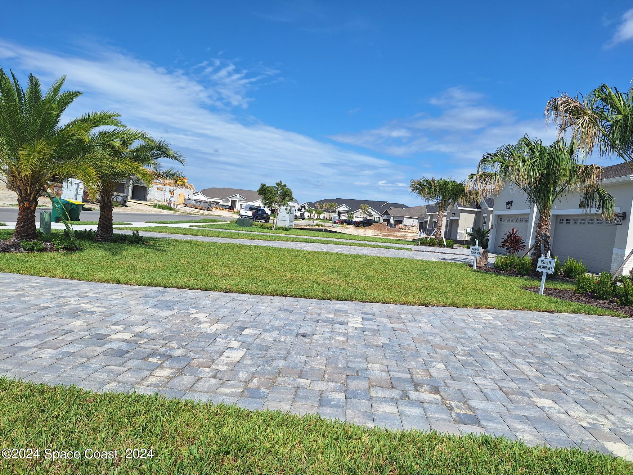 7929 Cache Crk Lane Melbourne, FL 32940 - Photo 20 of 33 a view of a house with a yard and potted plants