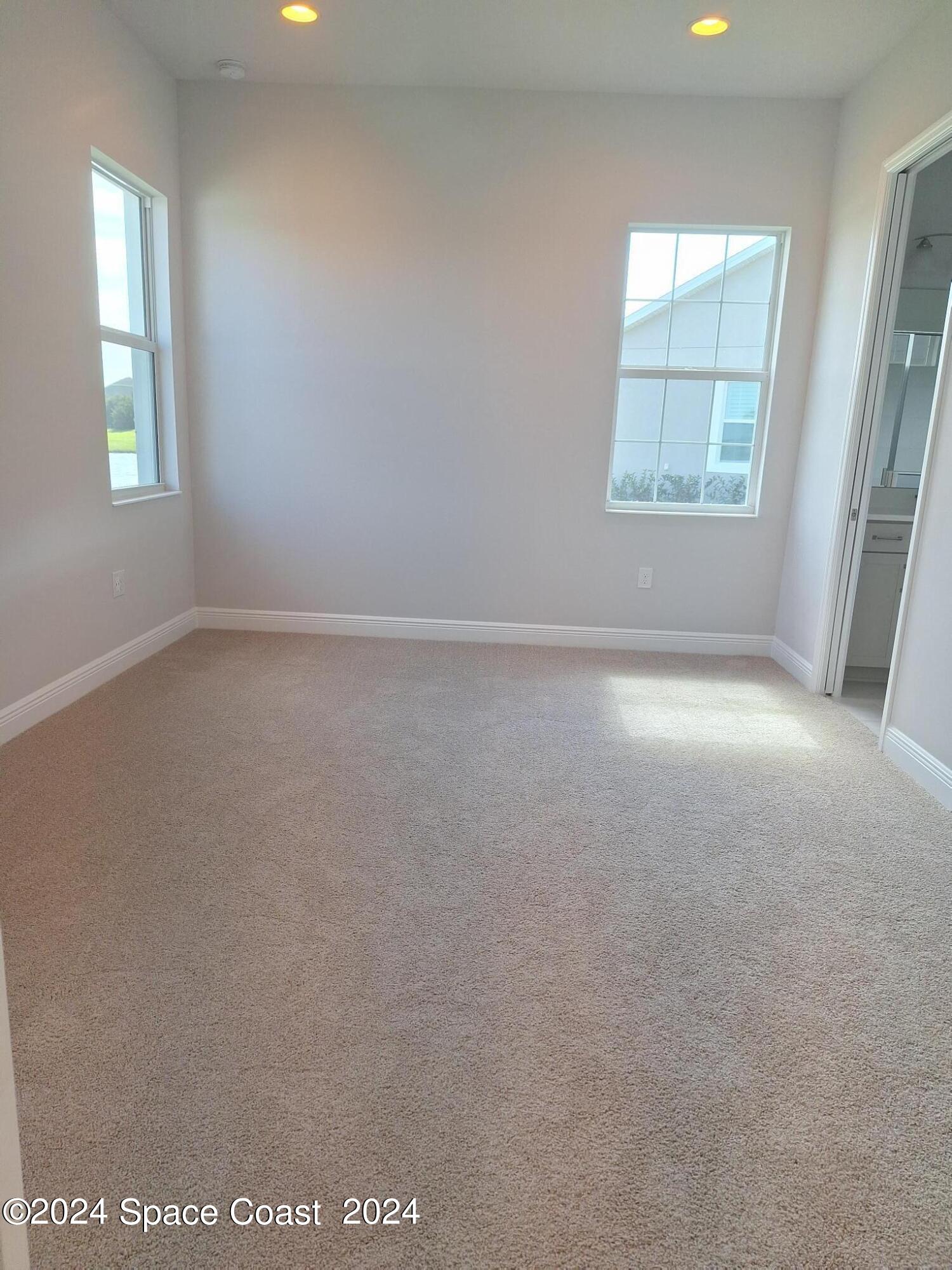 7929 Cache Crk Lane Melbourne, FL 32940 - Photo 9 of 33 an empty room with windows