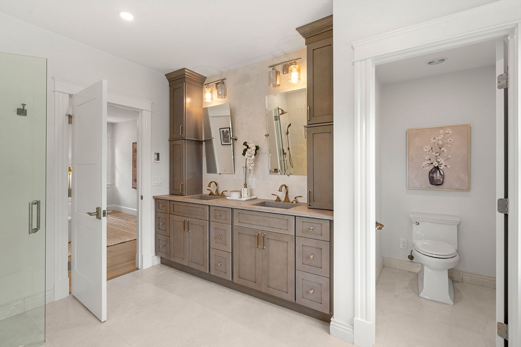 45 Sewall Street Newton, MA 02465 - Photo 14 of 21 a spacious bathroom with a double vanity sink a large mirror and a shower