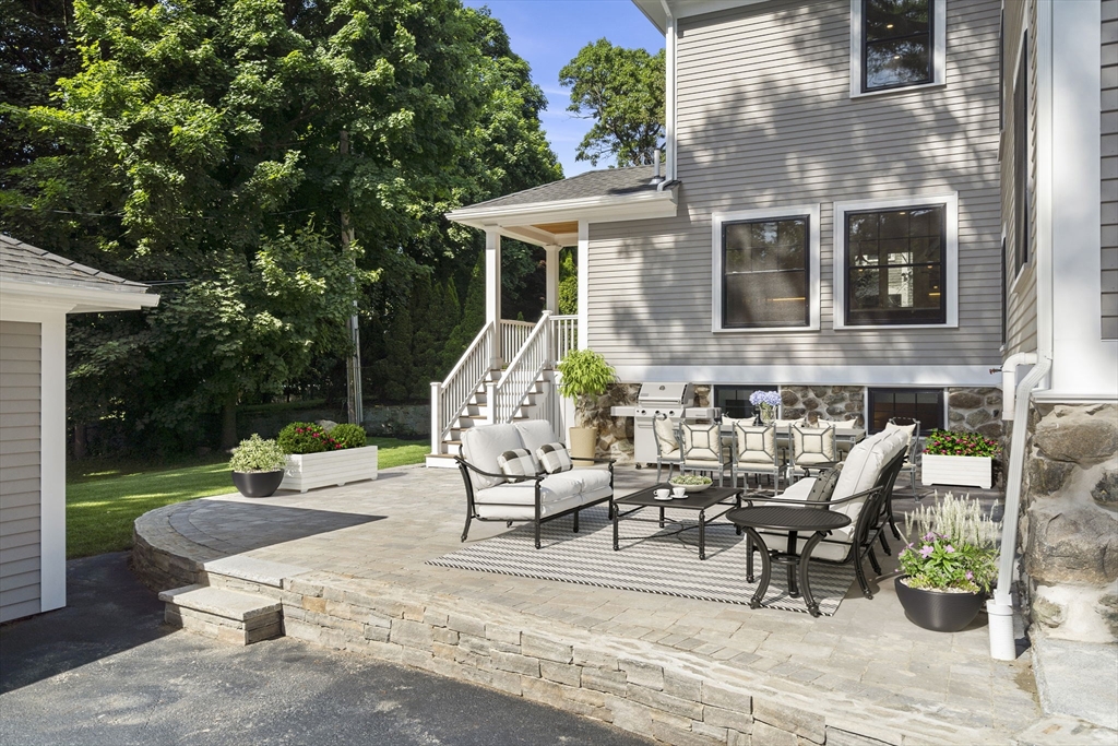 45 Sewall Street Newton, MA 02465 - Photo 2 of 21 a view of a patio with table and chairs potted plants with wooden fence