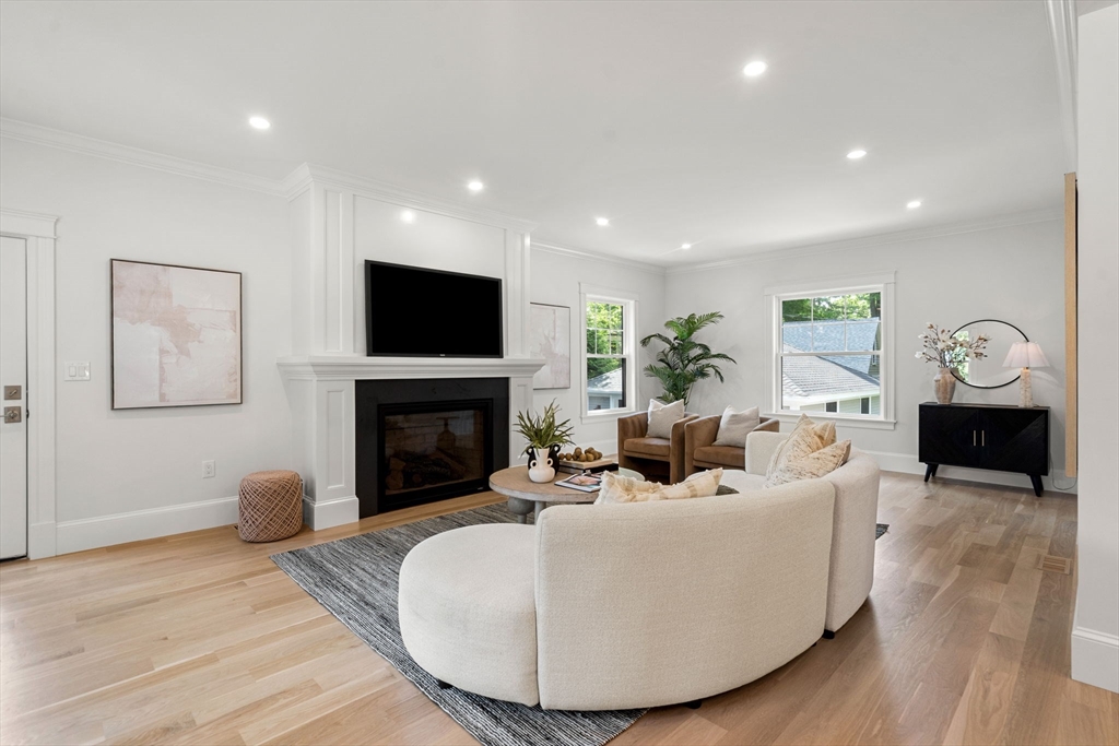 45 Sewall Street Newton, MA 02465 - Photo 6 of 21 a living room with furniture a fireplace and a flat screen tv