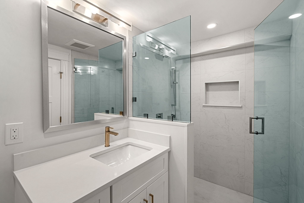 45 Sewall Street Newton, MA 02465 - Photo 9 of 21 a bathroom with a sink mirror and a shower