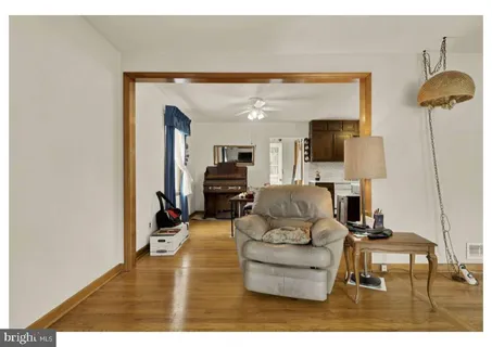 a living room with furniture and a lamp