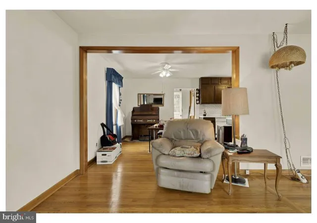 a living room with furniture and a lamp