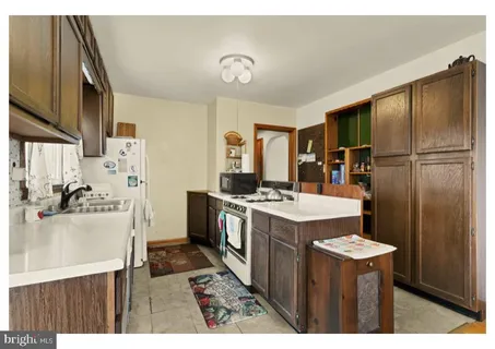 a kitchen with refrigerator and stove