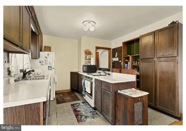 a kitchen with refrigerator and stove