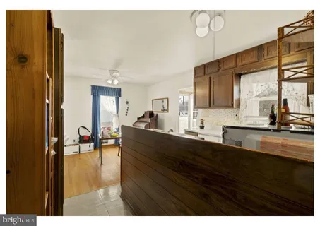 a living room with a table chairs and a dining table