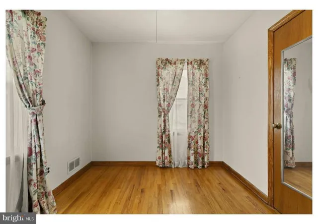 a view of an empty room and wooden floor