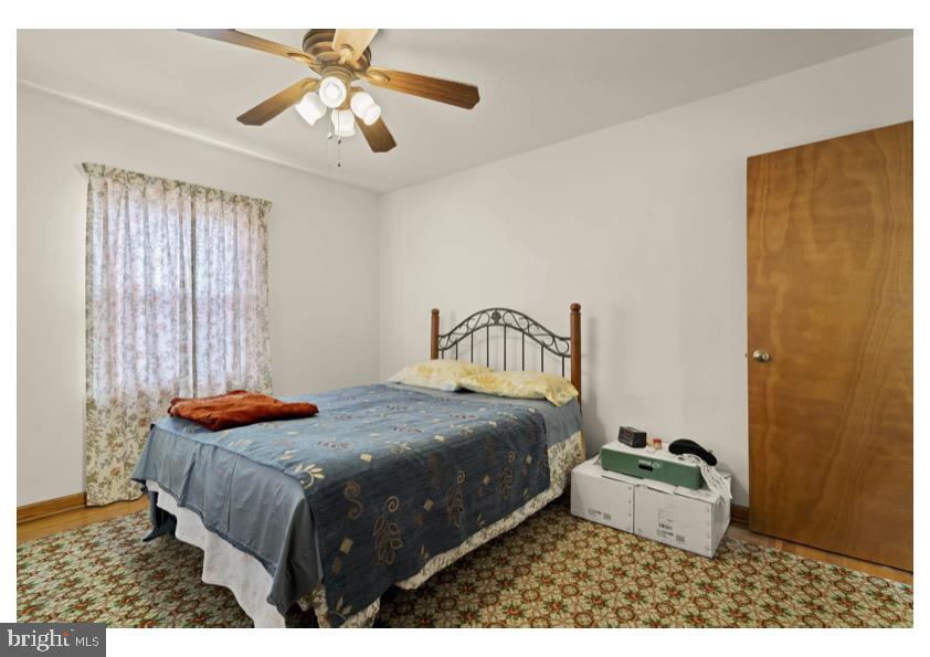 7524 Harmans Road Harmans, MD 21077 - Photo 22 of 40 a bedroom with a bed and a chandelier