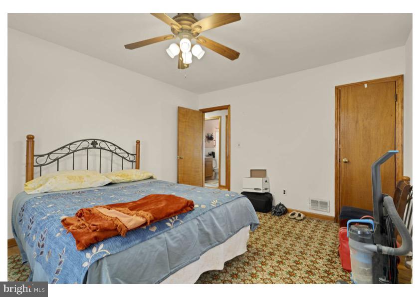 7524 Harmans Road Harmans, MD 21077 - Photo 23 of 40 a bedroom with a bed and a chandelier