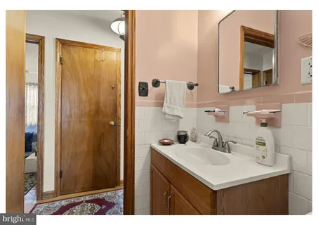 a bathroom with a sink mirror and vanity