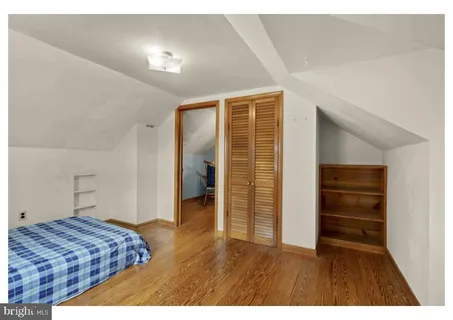 a bedroom with a bed and a walk in closet